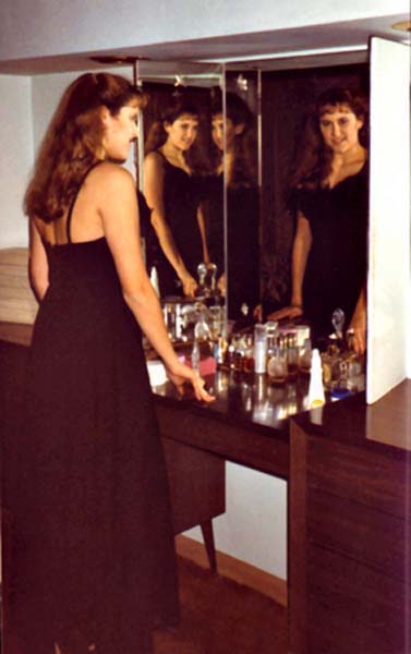 Janet in mirror, copyright 1990-2016 Janet Kuypers