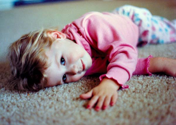 Claire laying on the carpet