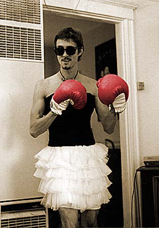 Eric Waters in a dress wearing boxing gloves
