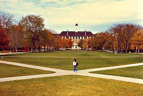 a student walking through the Quad at the University of Illi nois, copyright © 1988-2018 Janert Kuypers