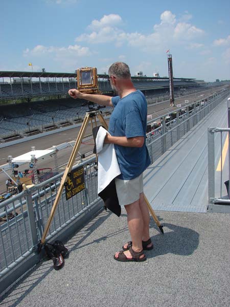 Frank photographing the Indy 500 in 2010 from the stands with an old camera and tripod