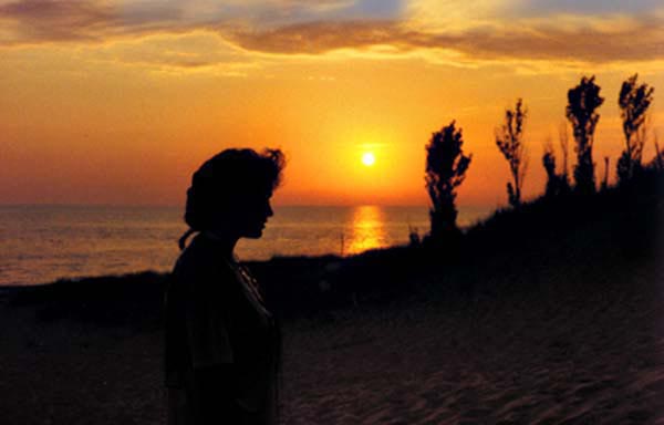 Ellen at sunset along the Male Michigan beach in Mighigan in 1988, Copyright © 1988-2018 Janet Kuypers