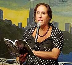 Janet Kuypers reading from the cc&d book “the 23 enigma” at her open mic feature in Chicago 20170822, image copyright © 2017-2018 Janet Kuypers